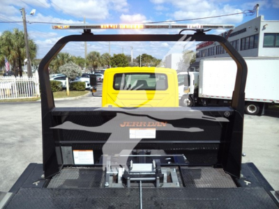 Back of a yellow International Durastar 4300 rollback truck with JERRDAN equipment and a visible rear hitch mechanism.