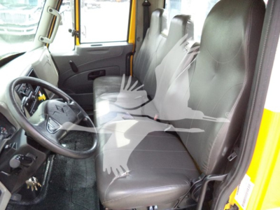 Interior of a 2019 International Durastar 4300 cab showing driver seat and passenger bench with steering wheel, dashboard, and door; no specific equipment labels visible in this shot.