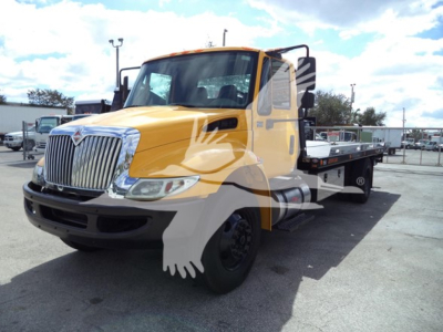 2019 International Durastar 4300 rollback truck showing front cab and flatbed with yellow paint and black wheels.