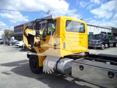 2019 International Durastar 4300 rollback truck cab with yellow body and damaged door area visible