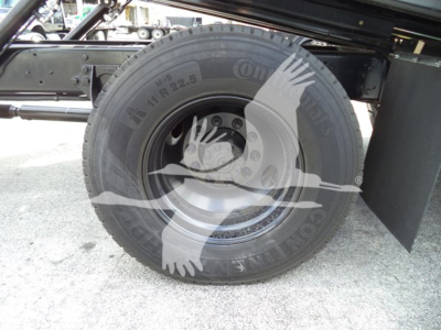 Truck wheel hub and tire on a 2019 International Durastar 4300 rollback chassis showing Continental tire with rim and rear fender.