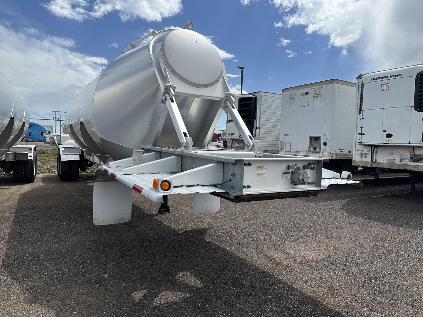 Trailer rear/side view of a 2012 Polar gravity drop pneumatic trailer showing a cylindrical tank and undercarriage with support frame and landing gear.