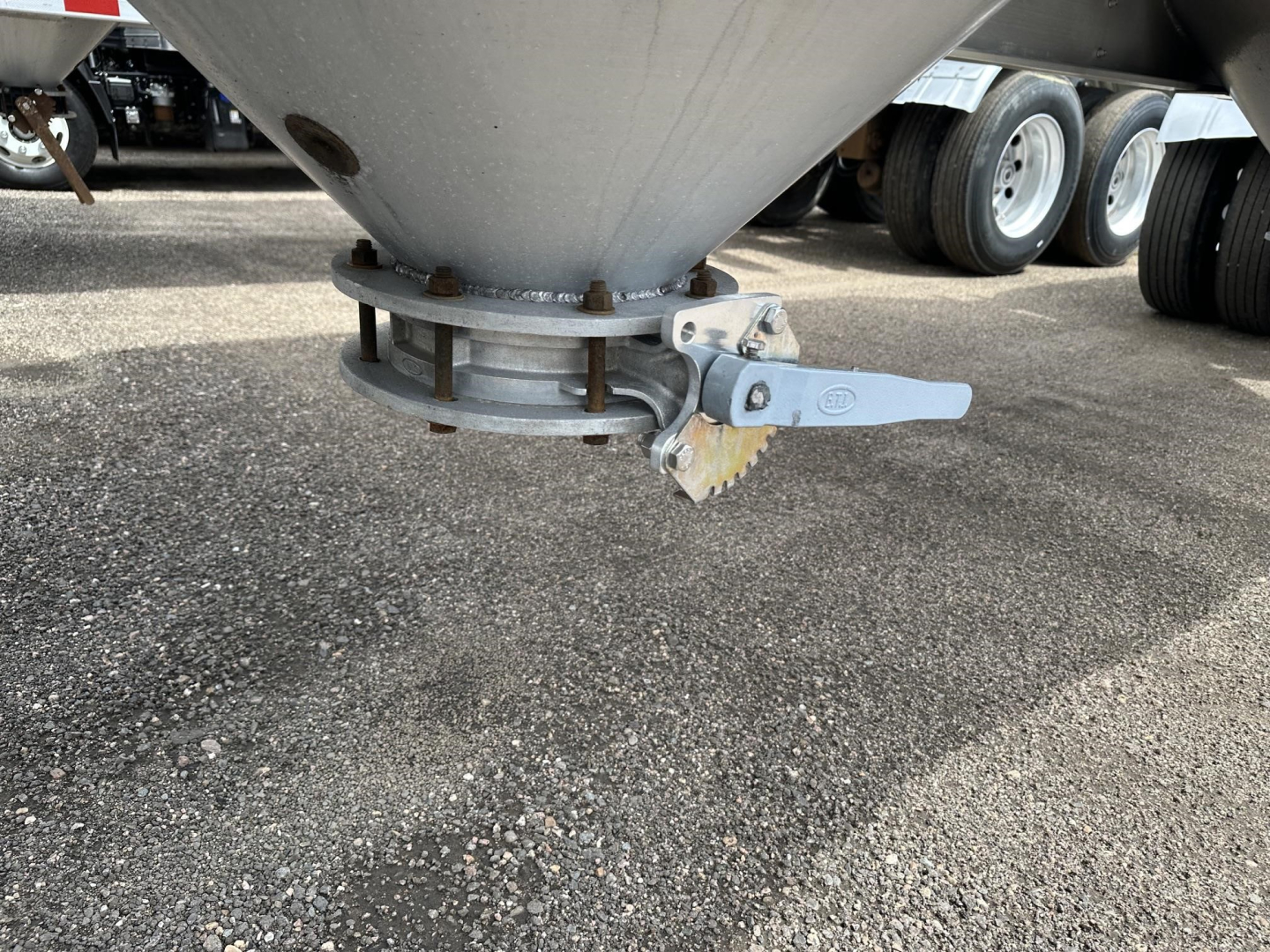 Pneumatic trailer bottom cone and quick-release latch showing clamp and wear ring, Polar Gravity Drop system component.