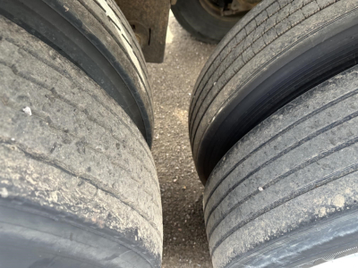 Pneumatic trailer axles and tires in view; inner tread shows wear; top and side view of dual tires for 2012 Polar Gravity Drop Pneumatic trailer.