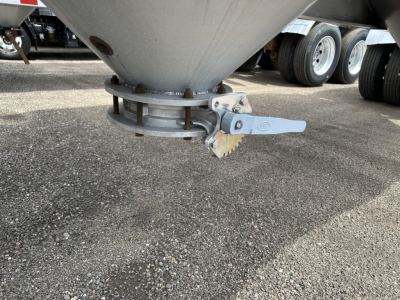 Pneumatic trailer bottom cone and quick-release latch showing clamp and wear ring, Polar Gravity Drop system component.