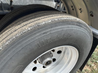 Trailer wheel showing tire marked 'HR24.5' and rim with central hub, part of Polar Gravity Drop pneumatic trailer.