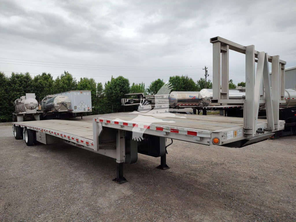 Flatbed trailer with drop deck and gooseneck support legs showing a long aluminum platform and rear cargo area.