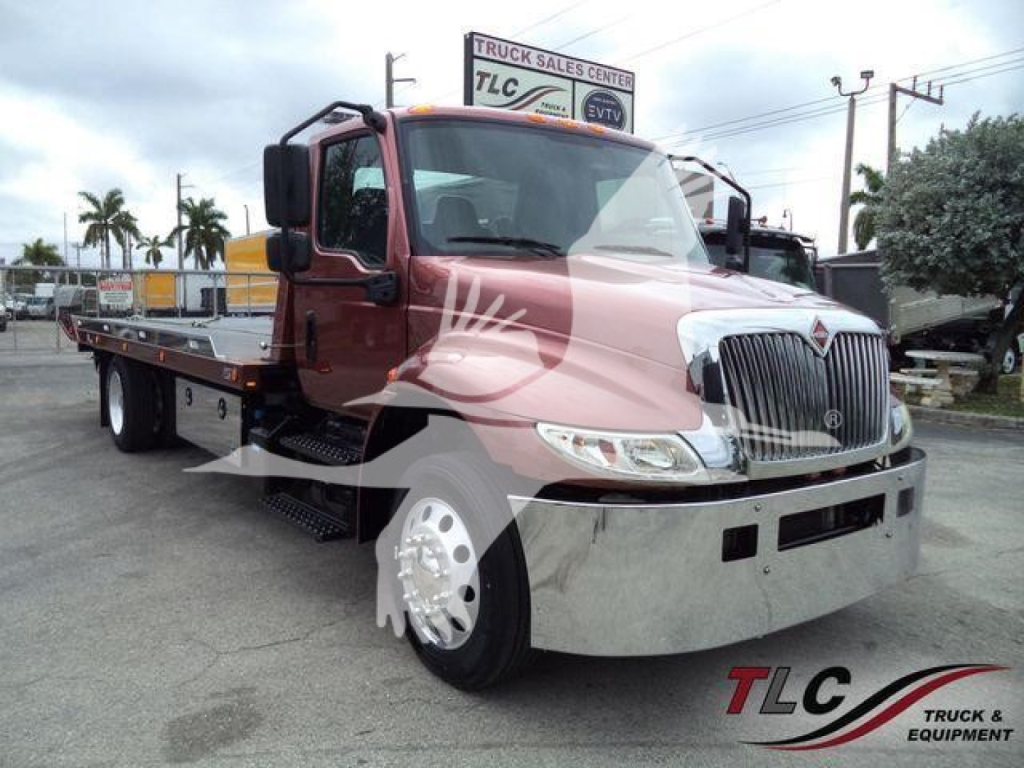2020 International MV rollback truck with front chrome bumper, dual headlights, and flatbed. Visible text includes TCL Truck & Equipment logo watermark on image.