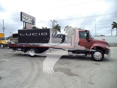 Truck bed with rollback wrecker on International MV, side profile showing flatbed and Lucid equipment, stock number T73951 visible.