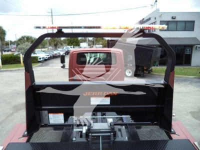 Truck bed with rollback equipment and mounting frame visible; EVAP and hydraulic components with hoses and controls.