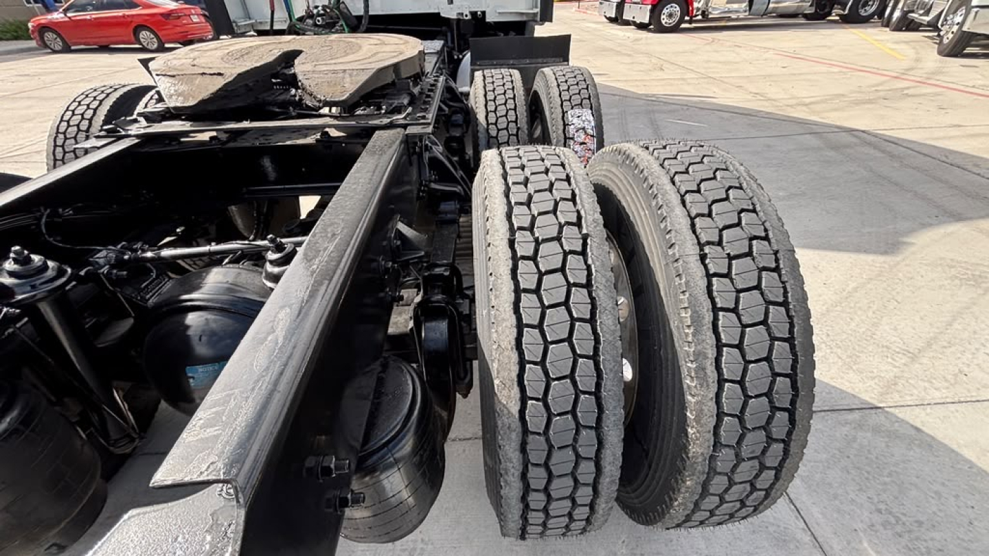 Kenworth T680 chassis showing twin rear axles and drive tires with visible frame rails.