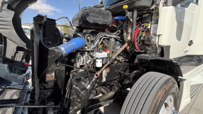 Kenworth T680 engine bay showing turbocharger, hoses, and various engine components.