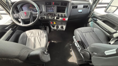 Kenworth T680 truck interior view showing steering wheel, dashboard, and two captain seats
