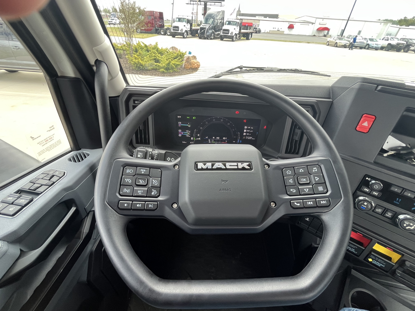 Mack AN64T interior steering wheel and cab controls visible.
