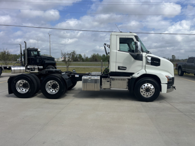Mack AN64T daycab tractor side view showing cab, fuel tanks, and dual rear axles with chrome wheels.