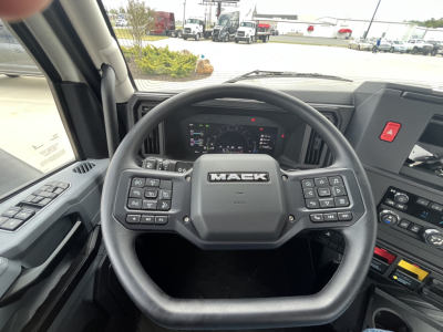 Mack AN64T interior steering wheel and cab controls visible.