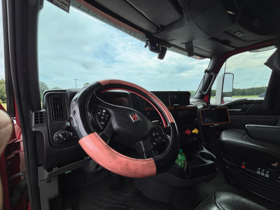 Interior of a 2020 International LT625 truck showing steering wheel, dashboard, and driver seat area.