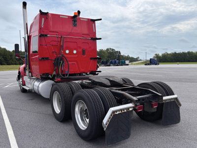 Rear view of a red 2020 International LT625 conventional sleeper truck showing dual rear axles, chassis, and mud flaps.