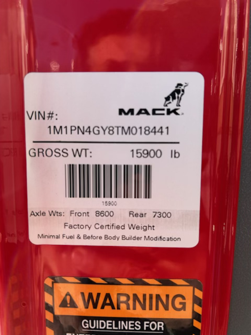 Mack PI64T cab label showing VIN 1M1PN4GY8TM018441 and gross weight 15900 lb with axle weights 8600 front and 7300 rear.