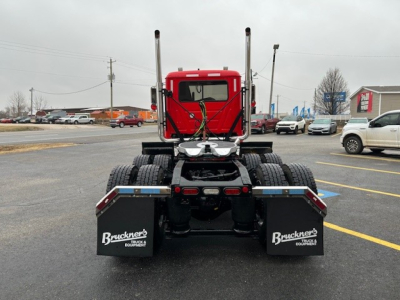 Tractor cab rear view of a 2026 Mack PI64T truck showing dual rear mud flaps with Bruckner’s Equipment branding and rear chassis components.