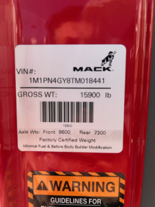 Mack PI64T cab label showing VIN 1M1PN4GY8TM018441 and gross weight 15900 lb with axle weights 8600 front and 7300 rear.