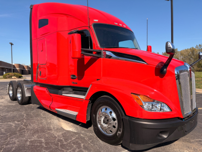 Kenworth T680 tractor-trailer in red, angled front-left view, showing aerodynamic cab, chrome front grille, side mirrors, and dual rear axles.