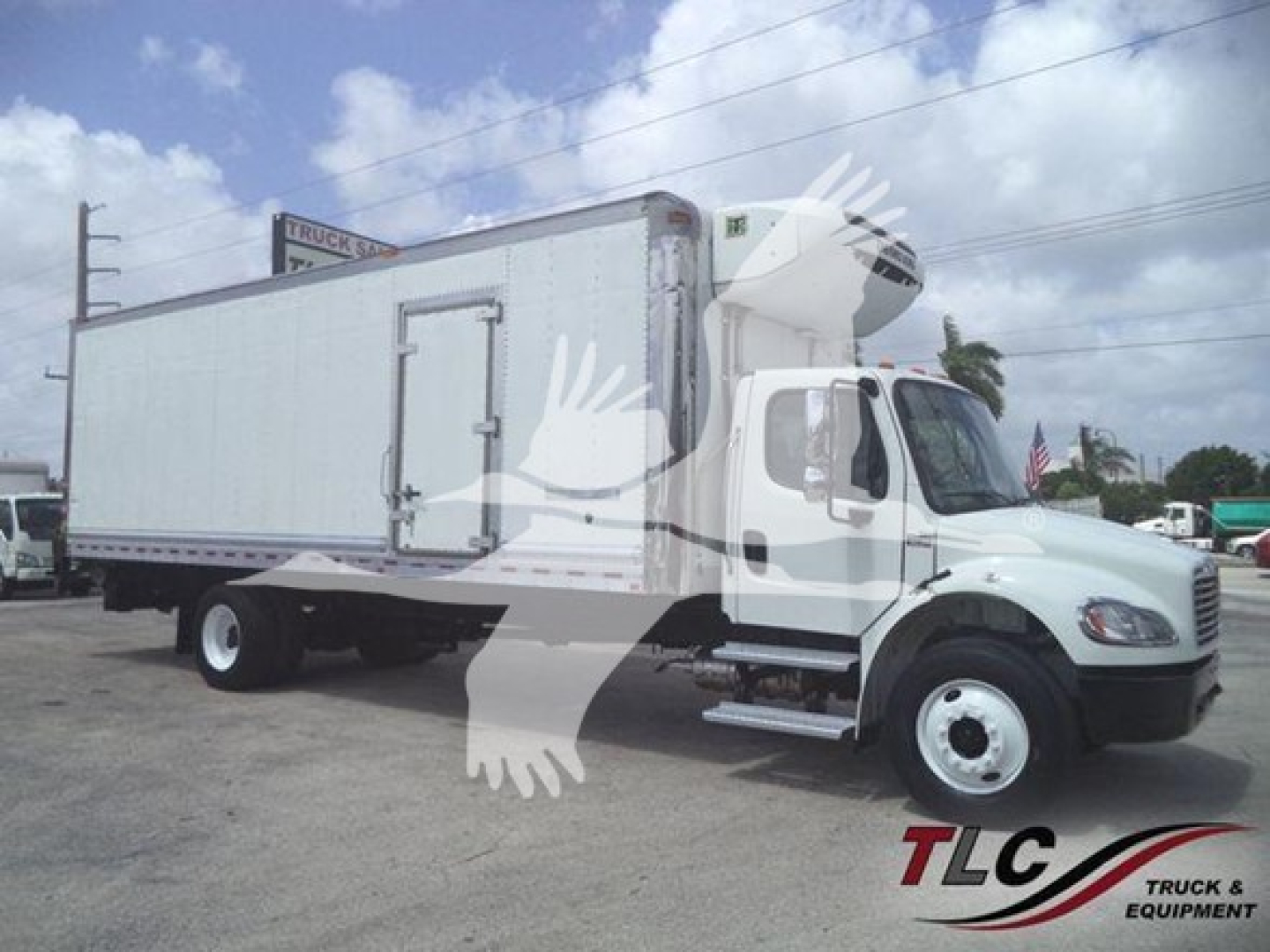 Freightliner Business Class M2 106 box truck with a large refrigerated cargo area and a vertical exhaust on the side; white cab and box.