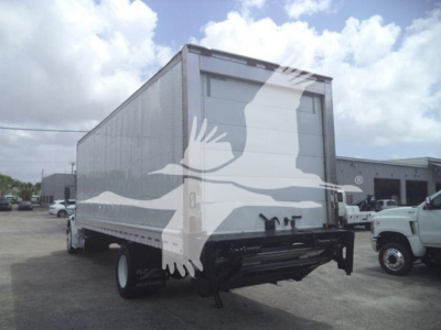 Freightliner M2 106 box truck rear view showing cargo trailer with white body and black bumper