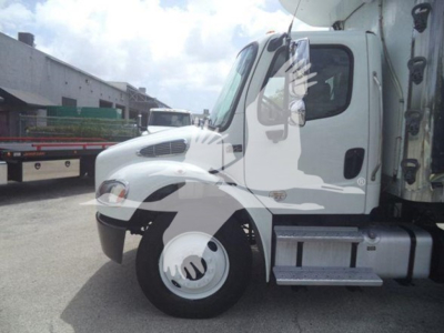 Freightliner M2 106 side view showing cab and front wheel with fuel tank and steps.