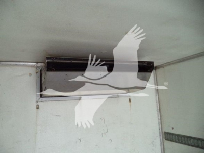 Truck body interior showing cargo area with metal side walls and a sliding door rail; no legible labels or brand text visible.