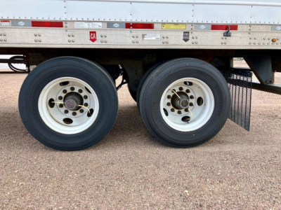 Dual rear trailer wheels of a 2022 Utility Reefer trailer showing tandem axles and tires with white rims.