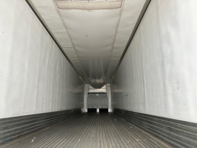 Trailer interior of a refrigerated 2022 Utility Reefer showing a long empty cargo space with ribbed floor and a cab at the far end.