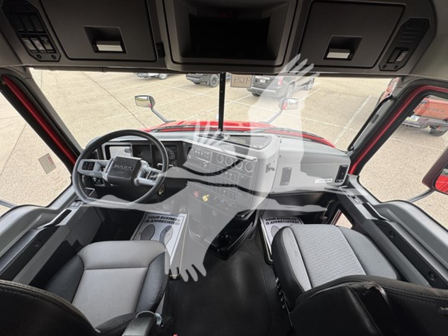 Cab interior of a 2019 Mack Anthem 64T truck showing steering wheel, dash, and seating from the driver's perspective.