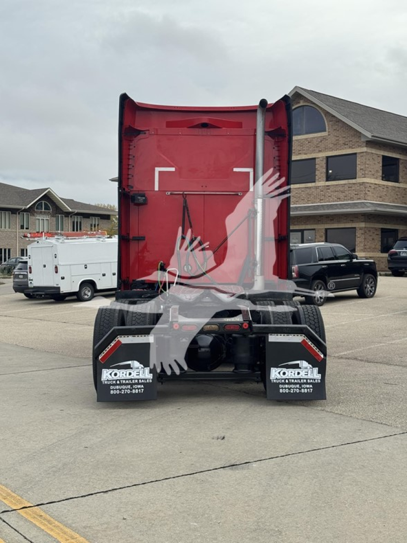 Truck rear view of 2019 Mack Anthem 64T Sleeper showing red dump bed and dual rear wheels with Korilla tank mats in a dealership lot.