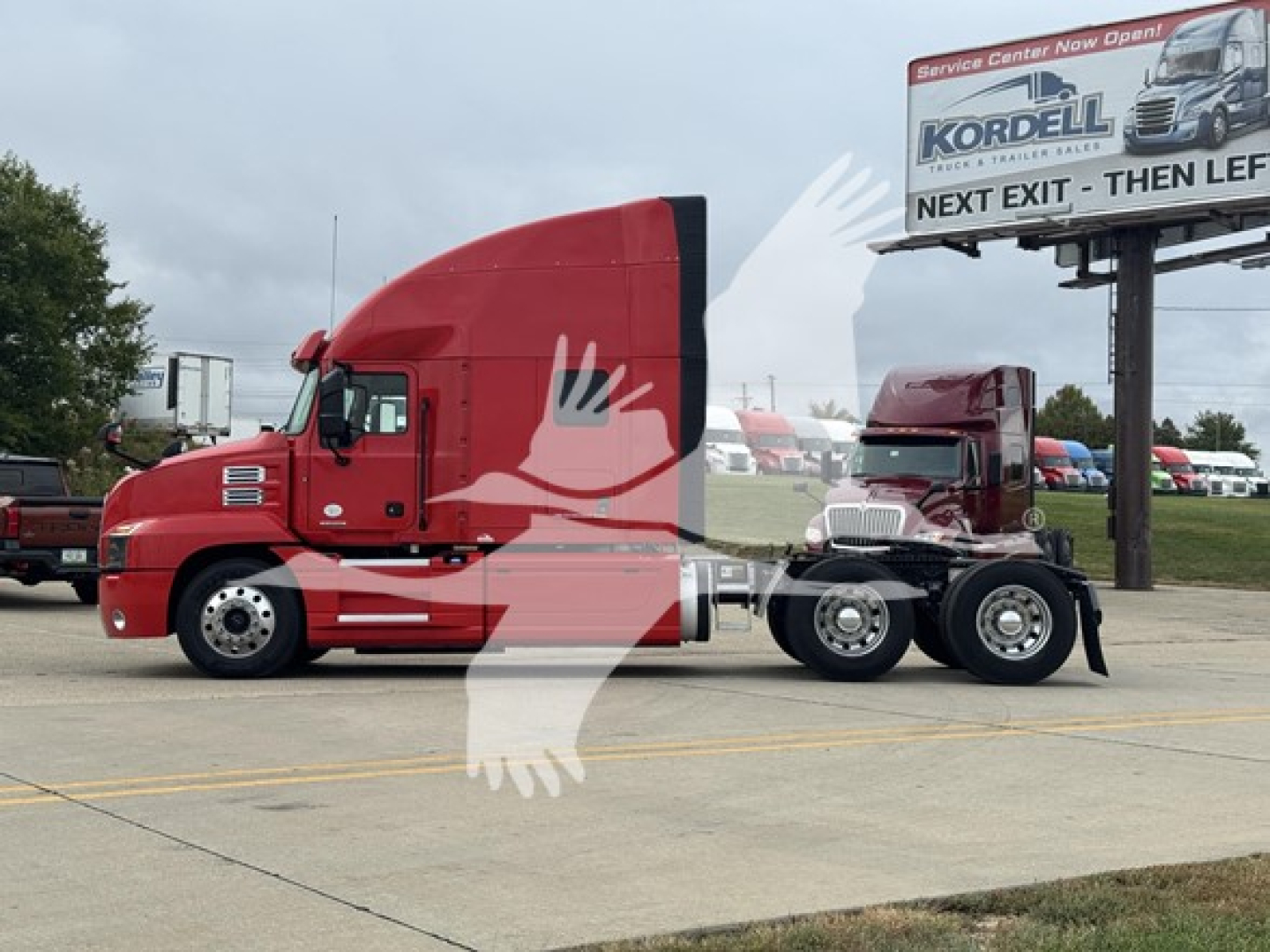 2019 Mack Anthem 64T tractor-trailer side view showing red cab and black chassis with sleeper, chrome wheels, and fifth wheel.