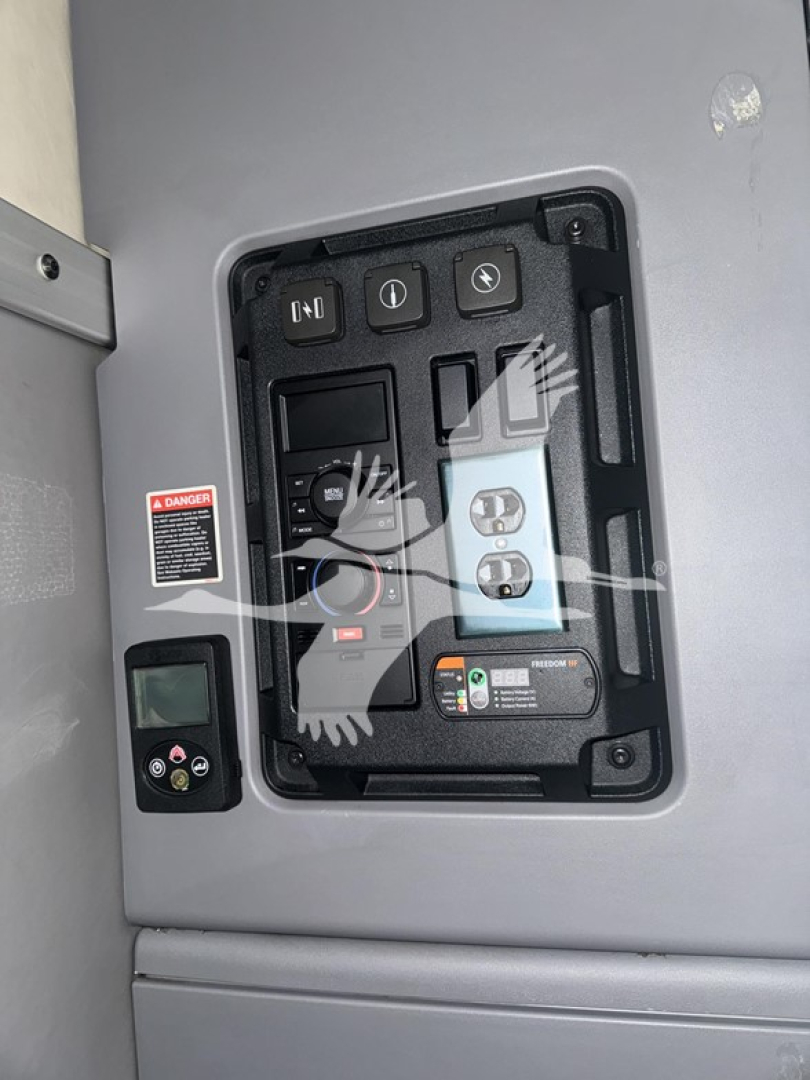 Panel view inside Mack Anthem 64T truck showing control switches and gauges in a recessed panel.