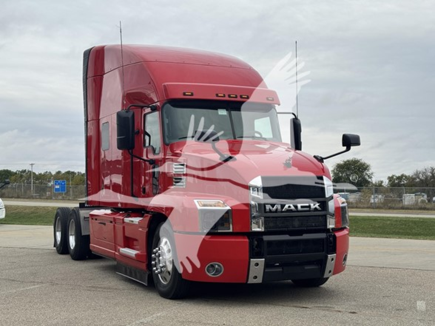 Truck cab showing 2019 Mack Anthem 64T with red paint, front grille with MACK letters, two side mirrors, daylight, 6x4 tractor.