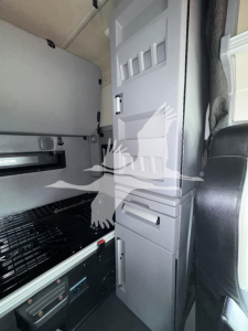 Mack truck cab interior showing divider cabinet and storage compartments in the sleeper area.