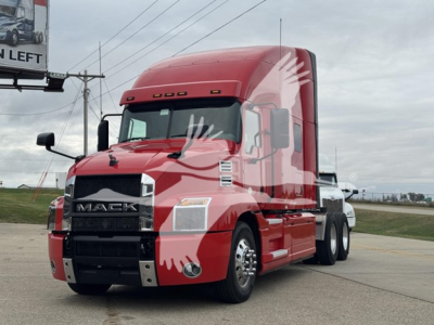Truck: 2019 Mack Anthem 64T in red, daytime side view showing front grille and cab.