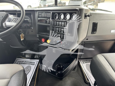 Mack Anthem 64T truck cab interior dash cluster showing windshield wipers, gauges, and center console with switches.