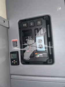 Panel view inside Mack Anthem 64T truck showing control switches and gauges in a recessed panel.