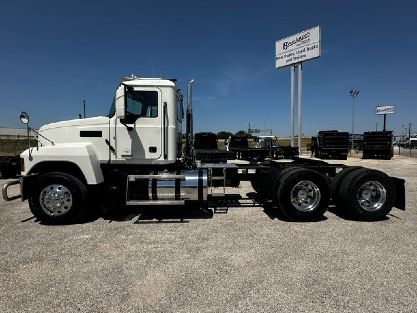 Truck cab and chassis showing 2020 Mack PI64T with white cab and dual rear axles.