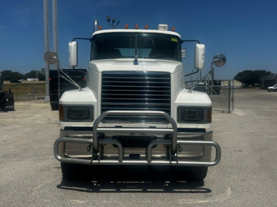 Front view of a white 2020 Mack PI64T conventional daycab truck with a heavy-duty bumper guard, grille, large side mirrors, and clearance lights.