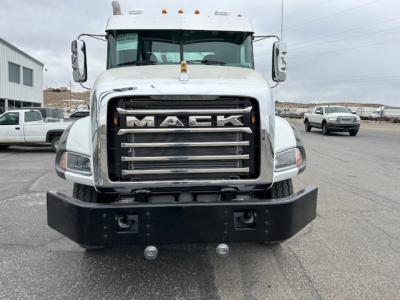 Mack GR64B truck front view showing bold chrome grille with 'MACK' lettering and heavy front bumper.