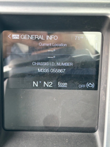 Mack GR64B truck cabin General Info display showing current location, chassis ID number M335 055867, N N2 econ off, with 71°F outside temp.