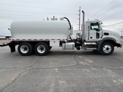 Mack GR64B vacuum tank truck side view showing cylindrical tank and cab with chrome exhaust