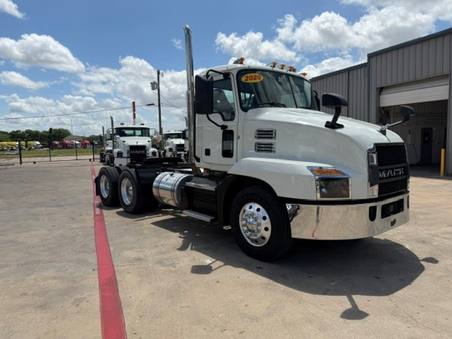 2020 Mack AN64T conventional daycab truck in a lot showing side view with sticker 2020 on windshield