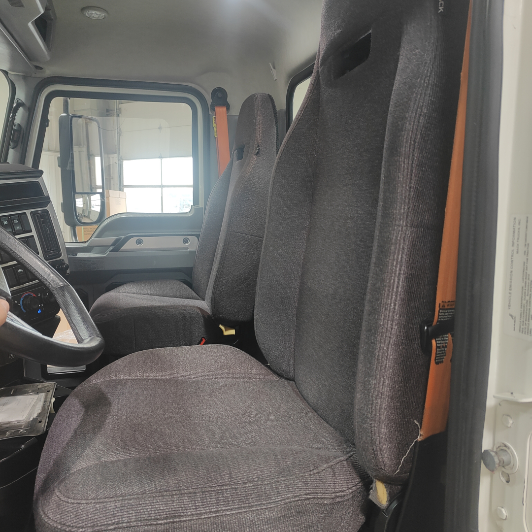 Mack AN64T cab interior showing driver seat and passenger seat in view.