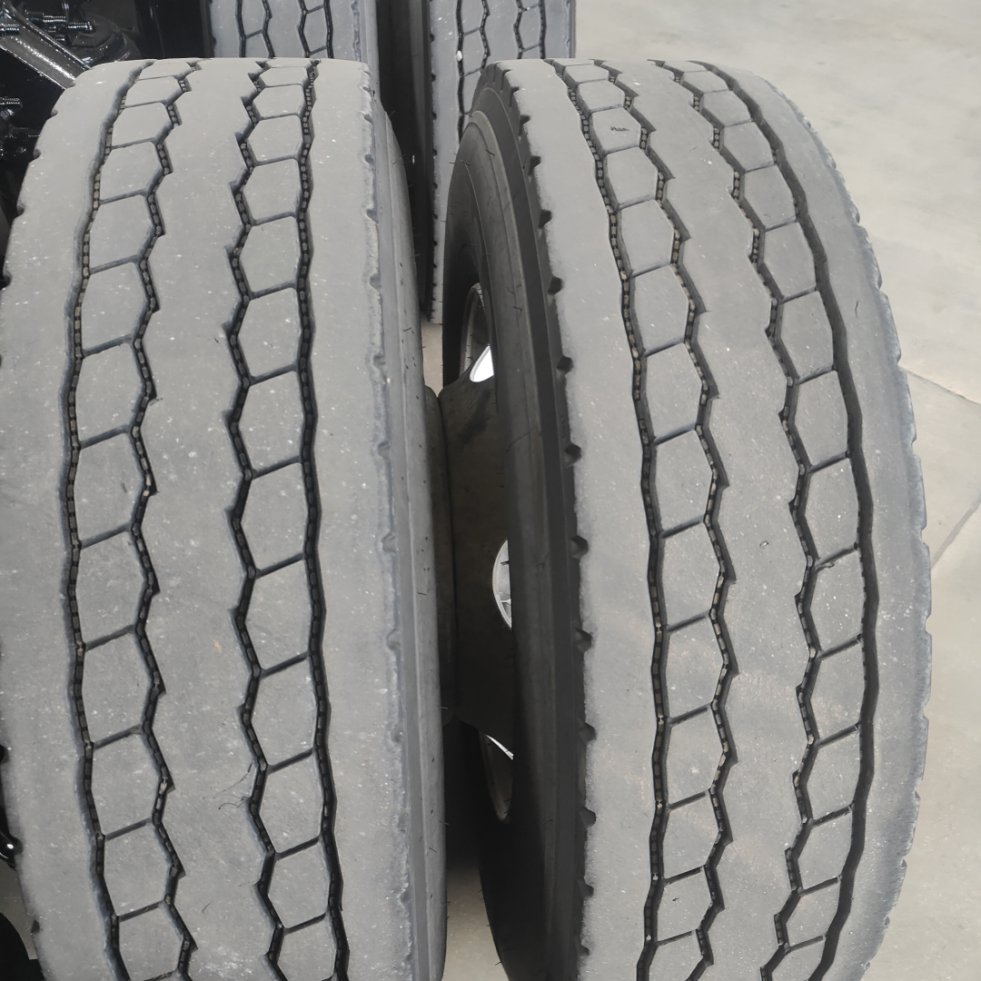 Dual rear truck tires on Mack AN64T clocked with tread pattern visible