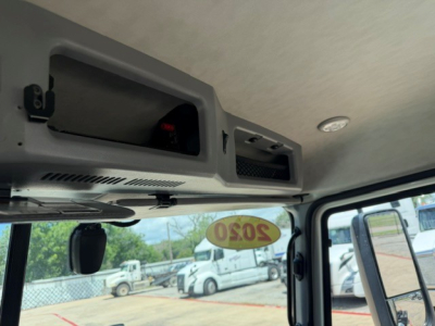 Truck cab interior overhead console with 2020 Mack AN64T chassis; windshield with 2020 sticker visible; front passenger area and sun visor hardware.